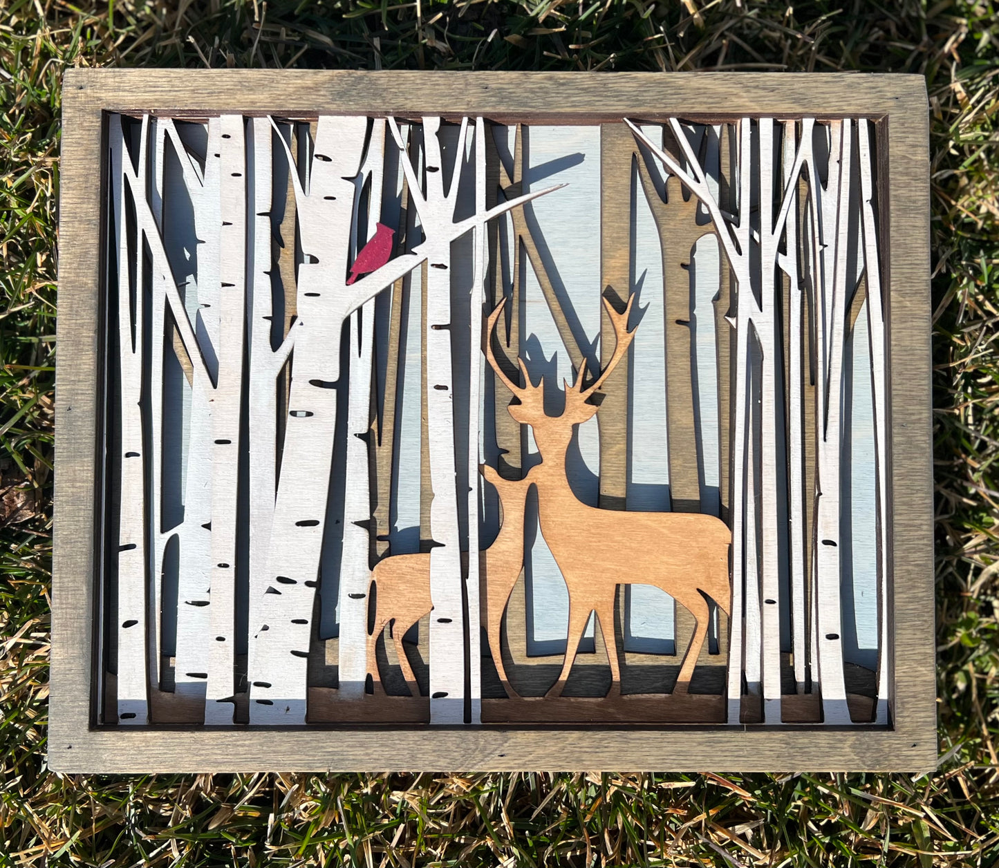 Layered deer in forest with cardinal