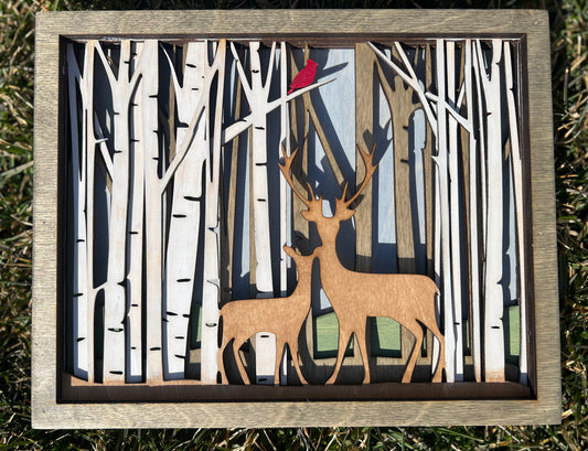 Layered deer in forest with cardinal